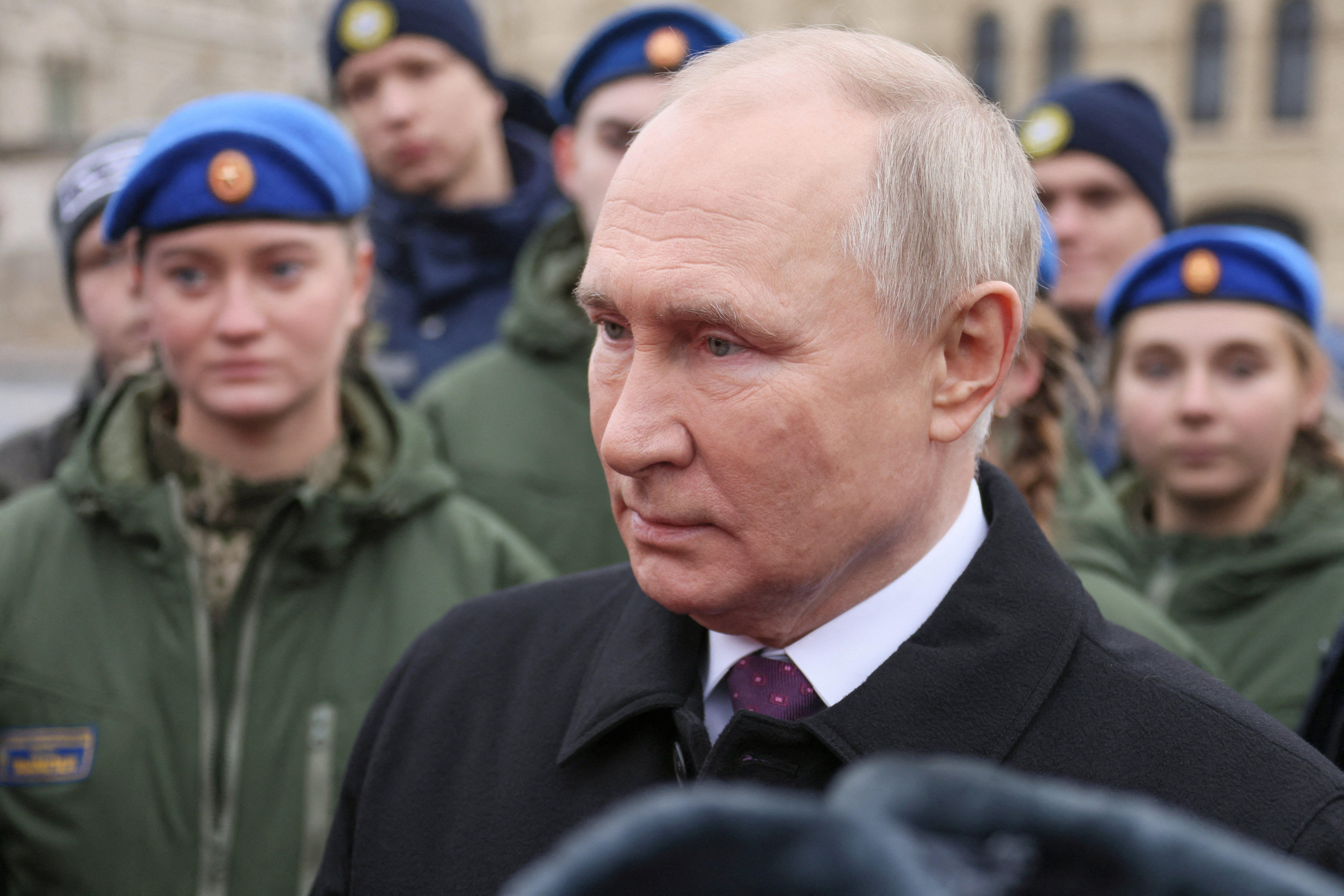 Russian President Vladimir Putin speaks with members of public associations, youth and volunteer organizations during a flower-laying ceremony at the monument to Kuzma Minin and Dmitry Pozharsky while marking Russia's Day of National Unity in Red Square in central Moscow, Russia November 4, 2023.