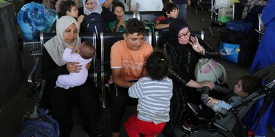 ​Scores of foreign passport holders trapped in Gaza started leaving the war-torn Palestinian territory on Nov. 1 -- some are seen here waiting at the Rafah border crossing in the southern Gaza Strip before crossing into Egypt. 