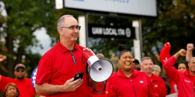 Shawn Fain, president of the United Auto Workers (UAW) speaks as President Joe Biden joins striking UAW members on the picket line in Belleville, Mich., in September.