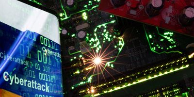 Smartphone with a displayed Russian flag with the word "Cyberattack" and binary codes over it is placed on a computer motherboard in this illustration.