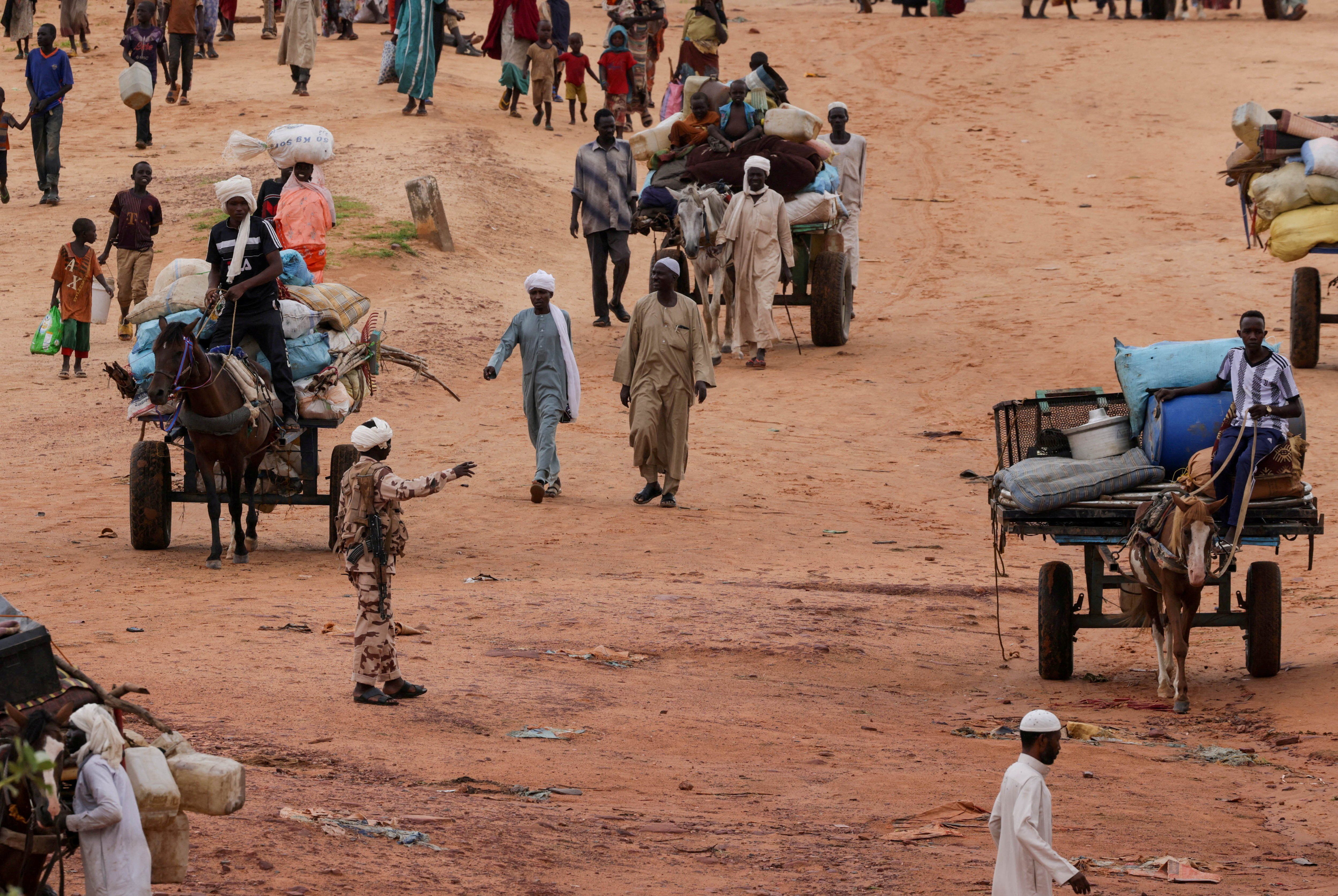 Sudanese who fled the conflict in Sudan's Darfur region, cross the border between Sudan and Chad. 