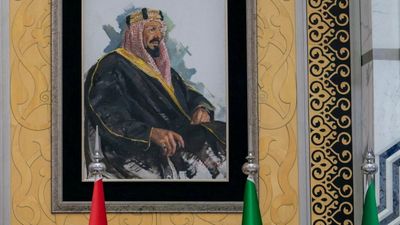 Syria's President Bashar al-Assad chats with Prince Badr bin Sultan bin Abdulaziz