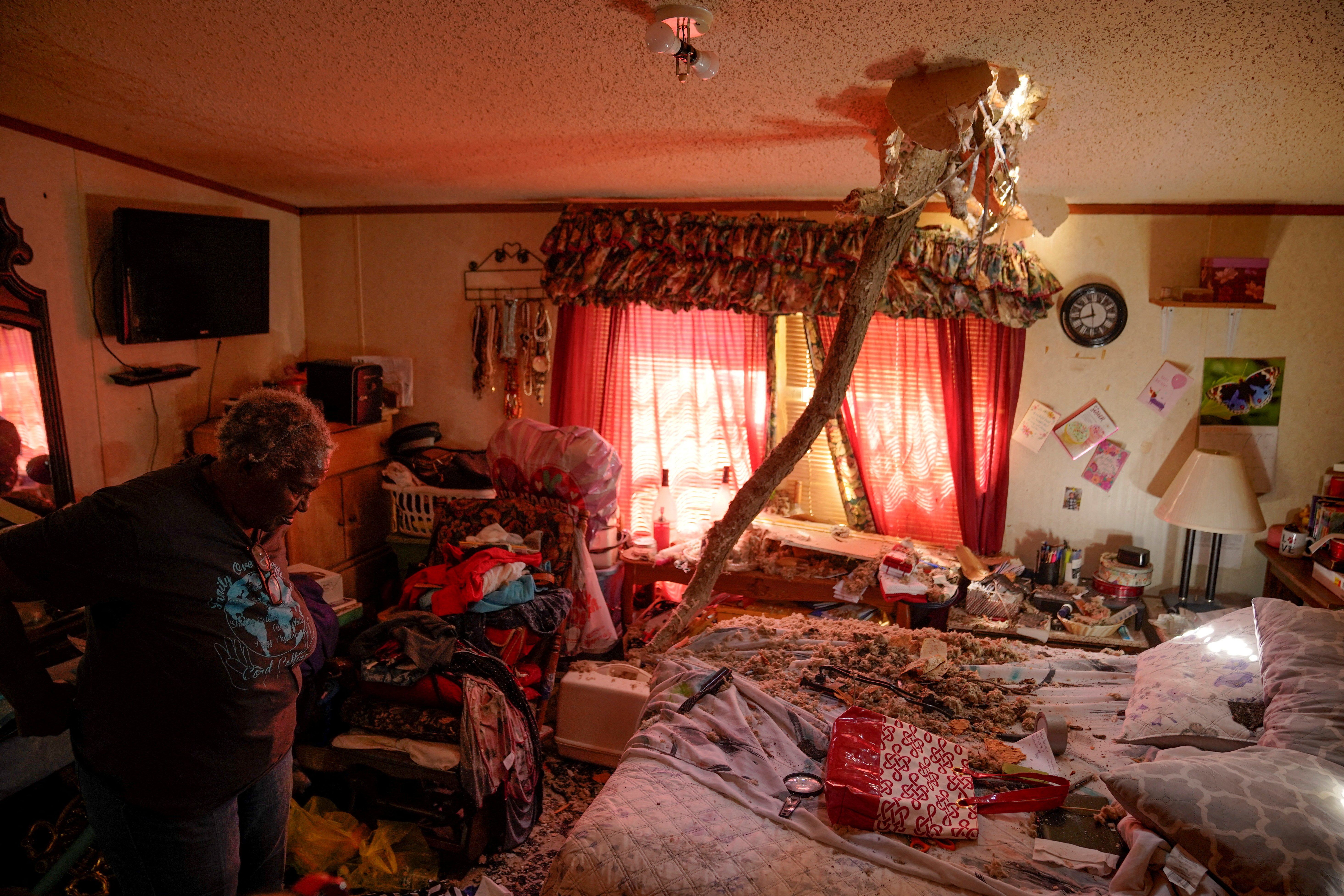 The aftermath of a tornado, in Wynne, Arkansas: A tree branch is seen impaled through the ceiling of a family home. 