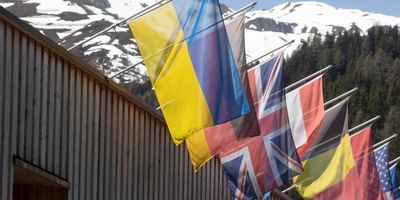 The national flag of Ukraine flies along with other countries' flags at the congress center for the 2022 edition of the World Economic Forum.