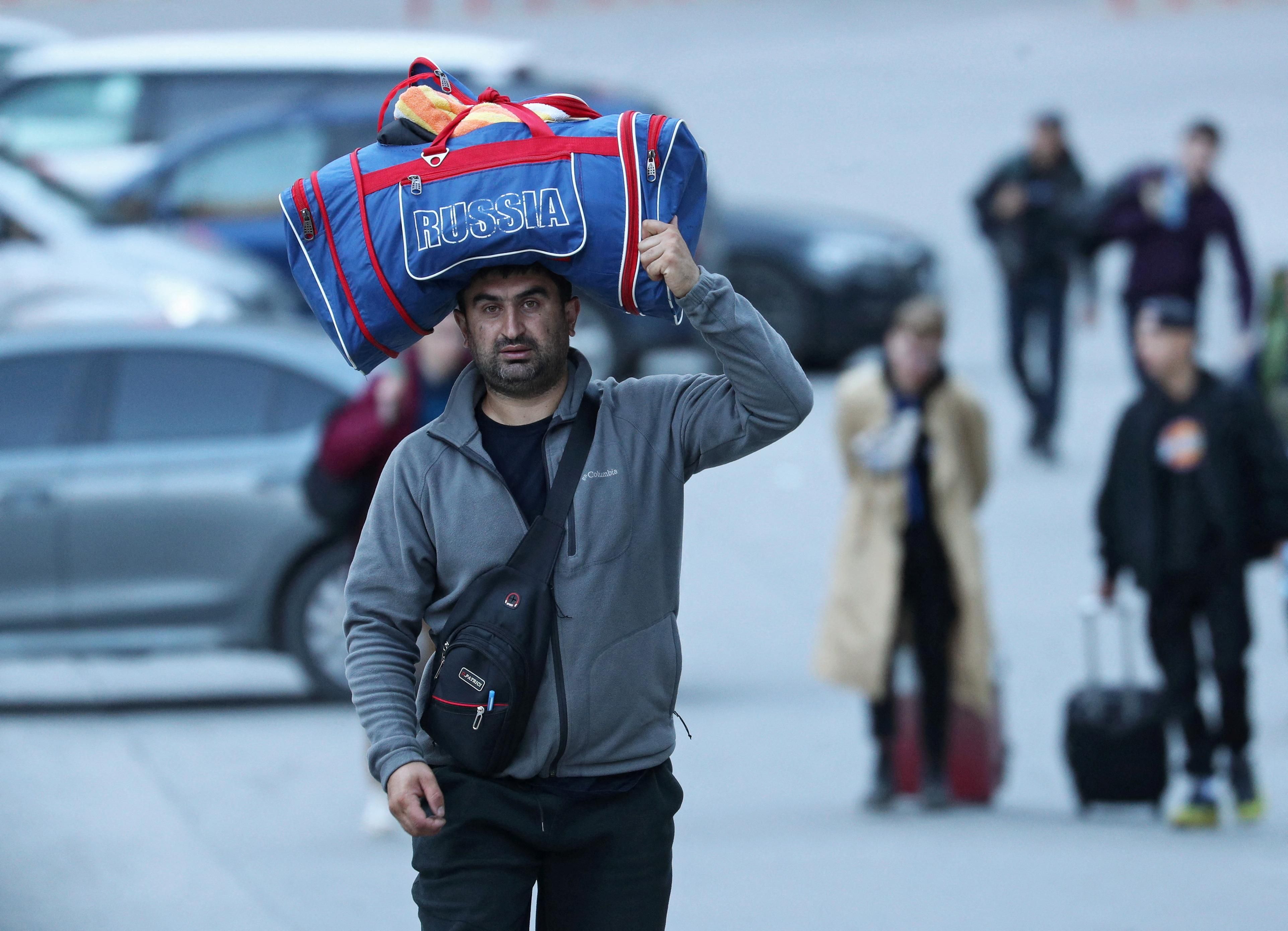 Travelers from Russia cross the border to Georgia. 