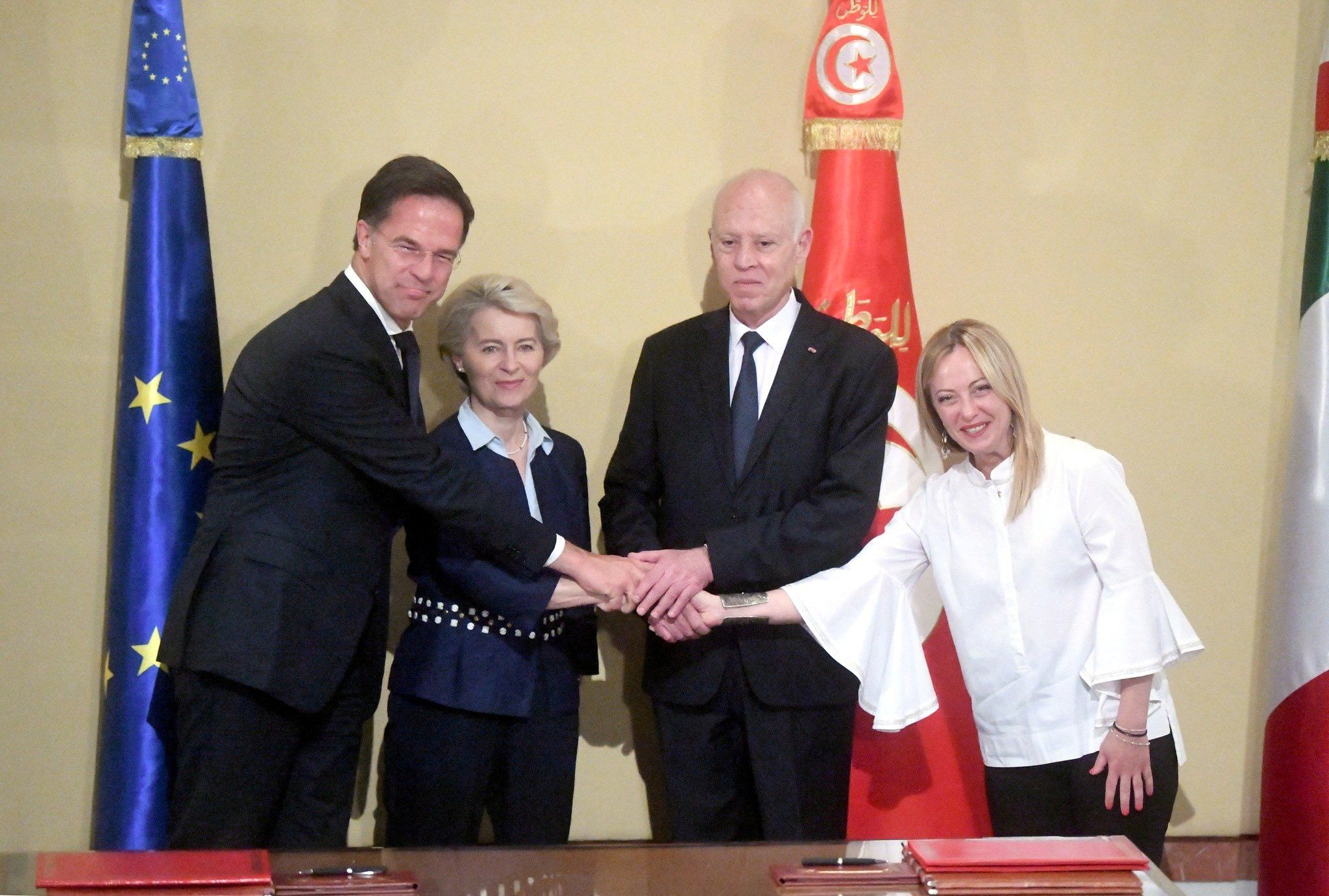 Tunisia's President Kais Saied, Italian Prime Minister Giorgia Meloni, European Commission President Ursula von der Leyen, and Dutch Prime Minister Mark Rutte shake hands during the signing of a "strategic partnership" 
