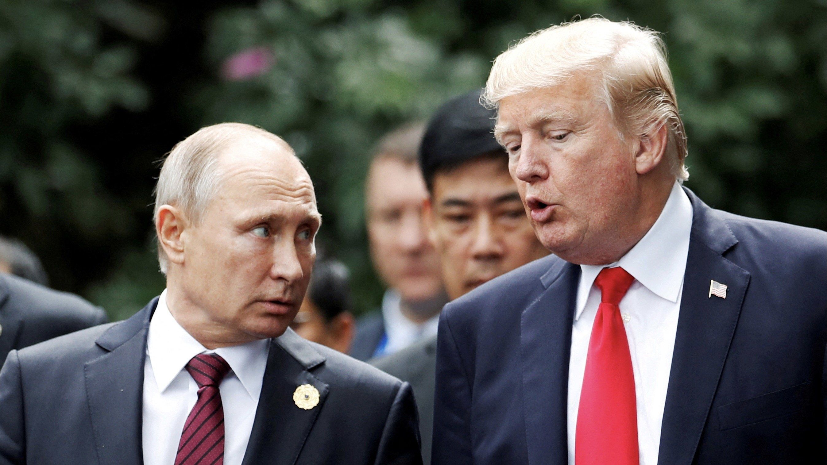 U.S. President Donald Trump and Russia's President Vladimir Putin talk during the family photo session at the APEC Summit in Danang, Vietnam November 11, 2017.
