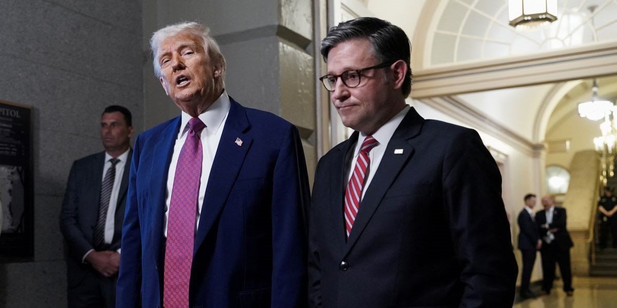 ​U.S. President Donald Trump speaks next to U.S. House Speaker Mike Johnson (R-LA), on the day of a closed House Republican Conference meeting on Capitol Hill in Washington, D.C., U.S., May 20, 2025. 