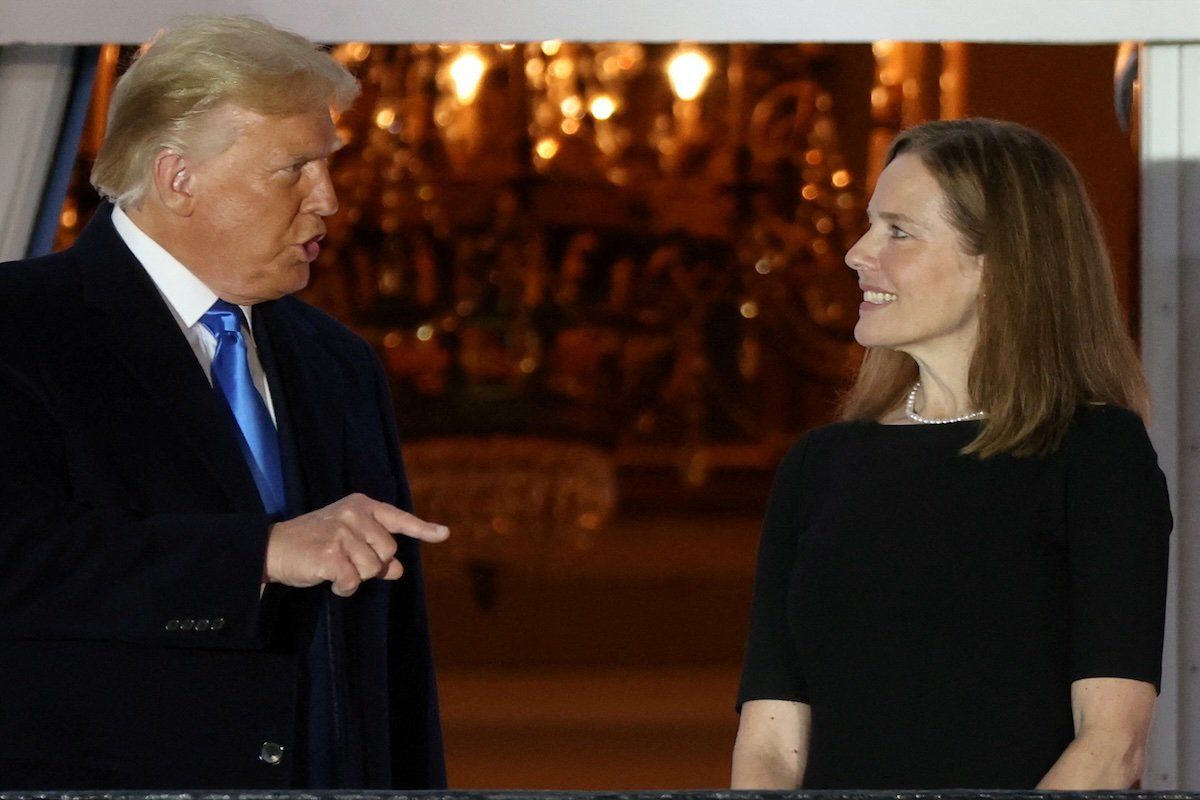 U.S. President Donald Trump speaks with Judge Amy Coney Barrett after she was sworn in as an associate justice of the U.S. Supreme Court on the South Lawn of the White House in Washington, U.S. October 26, 2020.
