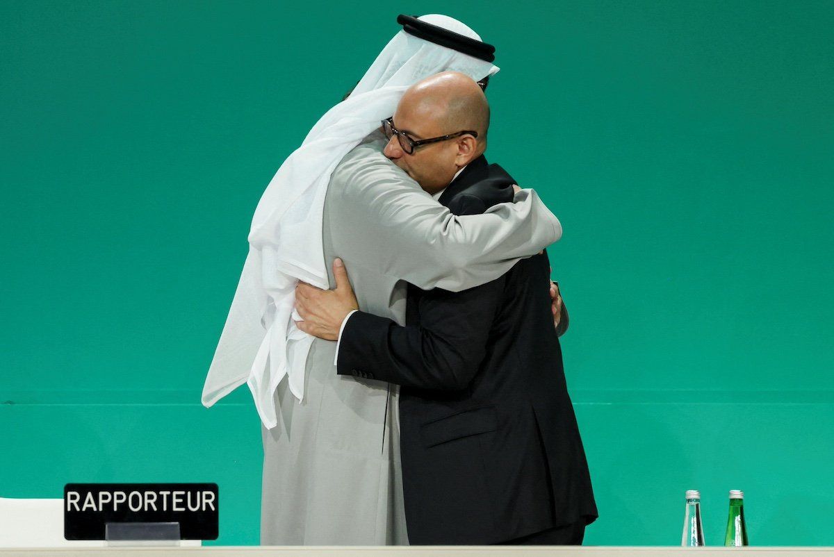 United Arab Emirates Minister of Industry and Advanced Technology and COP28 President, Sultan Ahmed Al Jaber, hugs Executive Secretary of UNFCCC Simon Stiell as they attend a plenary meeting, after a draft of a negotiation deal was released, at the United Nations Climate Change Conference COP28 in Dubai, United Arab Emirates, December 13, 2023.