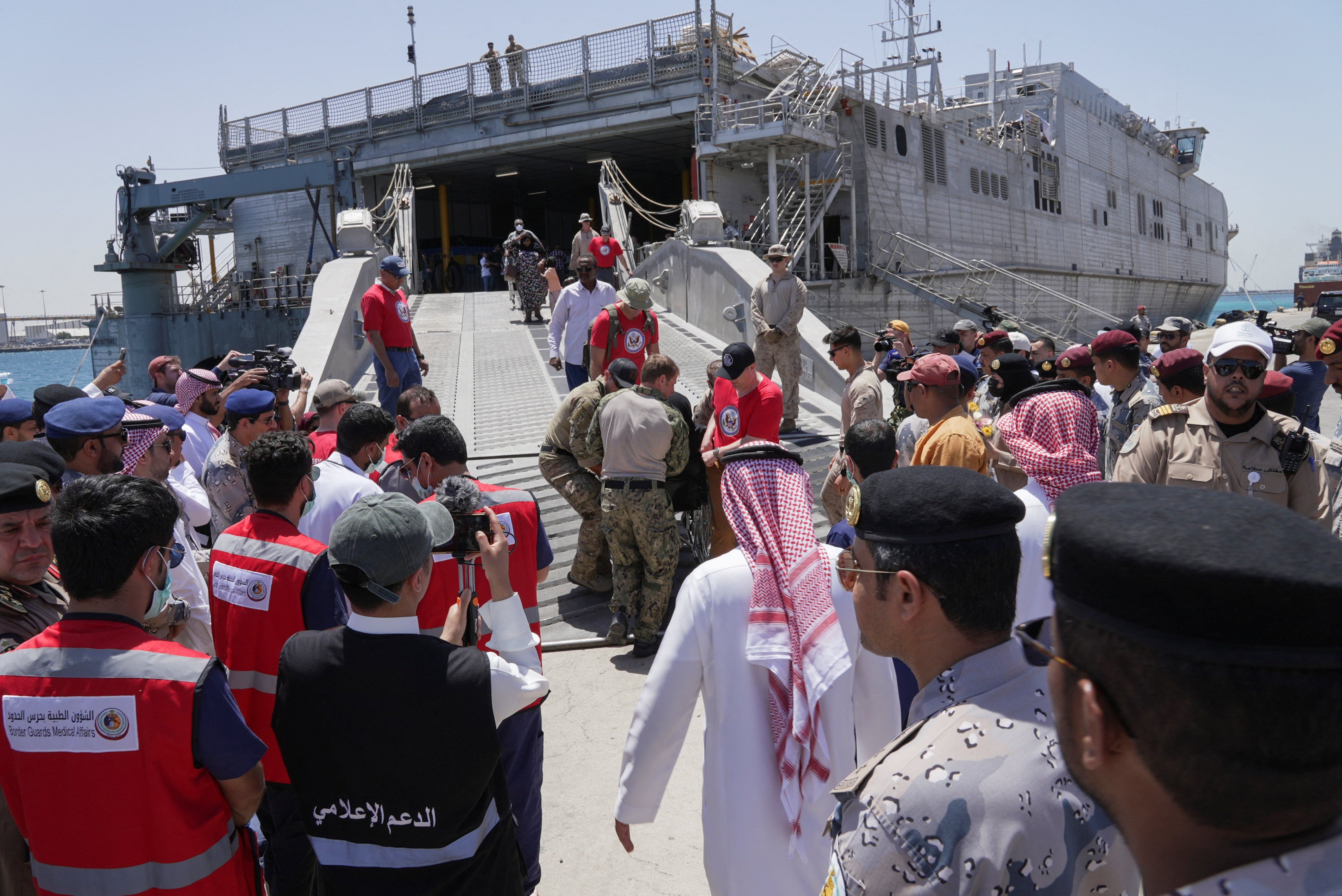 US embassy and navy officials help evacuees from Sudan disembark in Jeddah, Saudi Arabia.