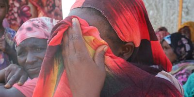Women from the city of Al-Junina (West Darfur) cry after receiving the news about the death of their relatives as they waited for them in Chad, Nov. 7, 2023.