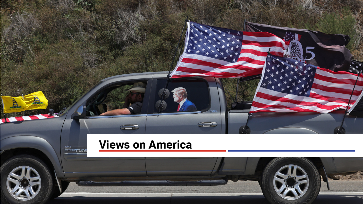 Malibu, California, USA: A pickup truck with a President Donald Trump decal and decorated in U.S. Flags drives on Pacific Coast Highway on July 4th in Malibu, California.