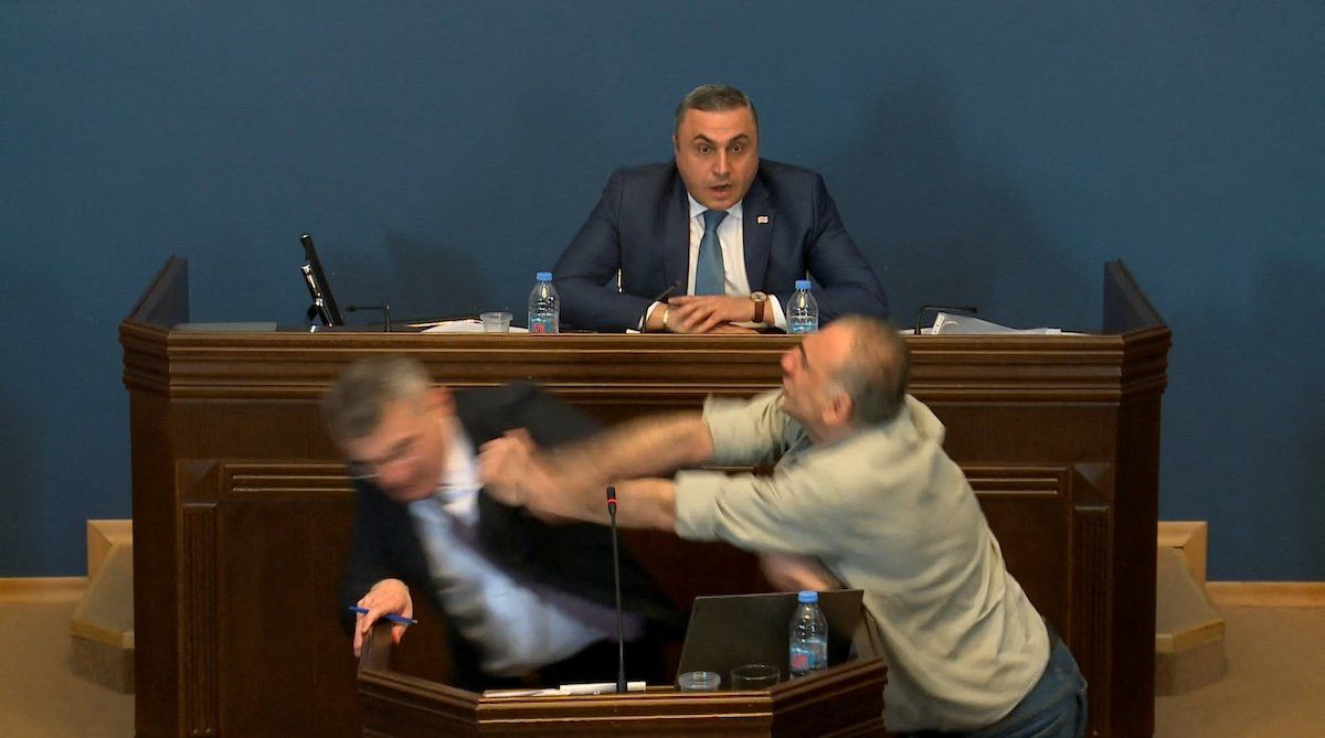 ​Mamuka Mdinaradze, leader of the ruling Georgian Dream party's parliamentary faction, is punched in the face by opposition MP Aleko Elisashvili during discussion of the bill on "foreign agents" in the Parliament, Tbilisi, Georgia, April 15, 2024 in this still image taken from a live broadcast video. 