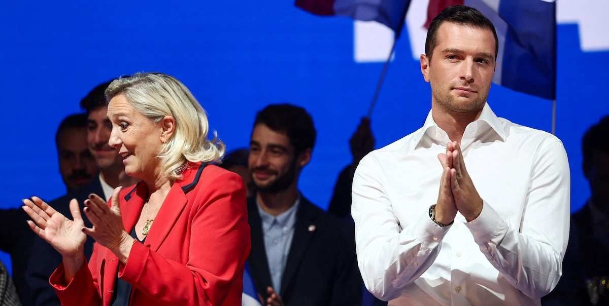 Marine Le Pen, French member of parliament and parliamentary leader of the far-right National Rally (Rassemblement National - RN) party and Jordan Bardella, president of the French far-right National Rally (Rassemblement National - RN) party and member of the European Parliament, gesture during an RN political rally in Bordeaux, France, September 14, 2025. 