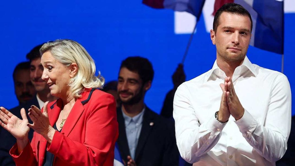 Marine Le Pen, French member of parliament and parliamentary leader of the far-right National Rally (Rassemblement National - RN) party and Jordan Bardella, president of the French far-right National Rally (Rassemblement National - RN) party and member of the European Parliament, gesture during an RN political rally in Bordeaux, France, September 14, 2025.