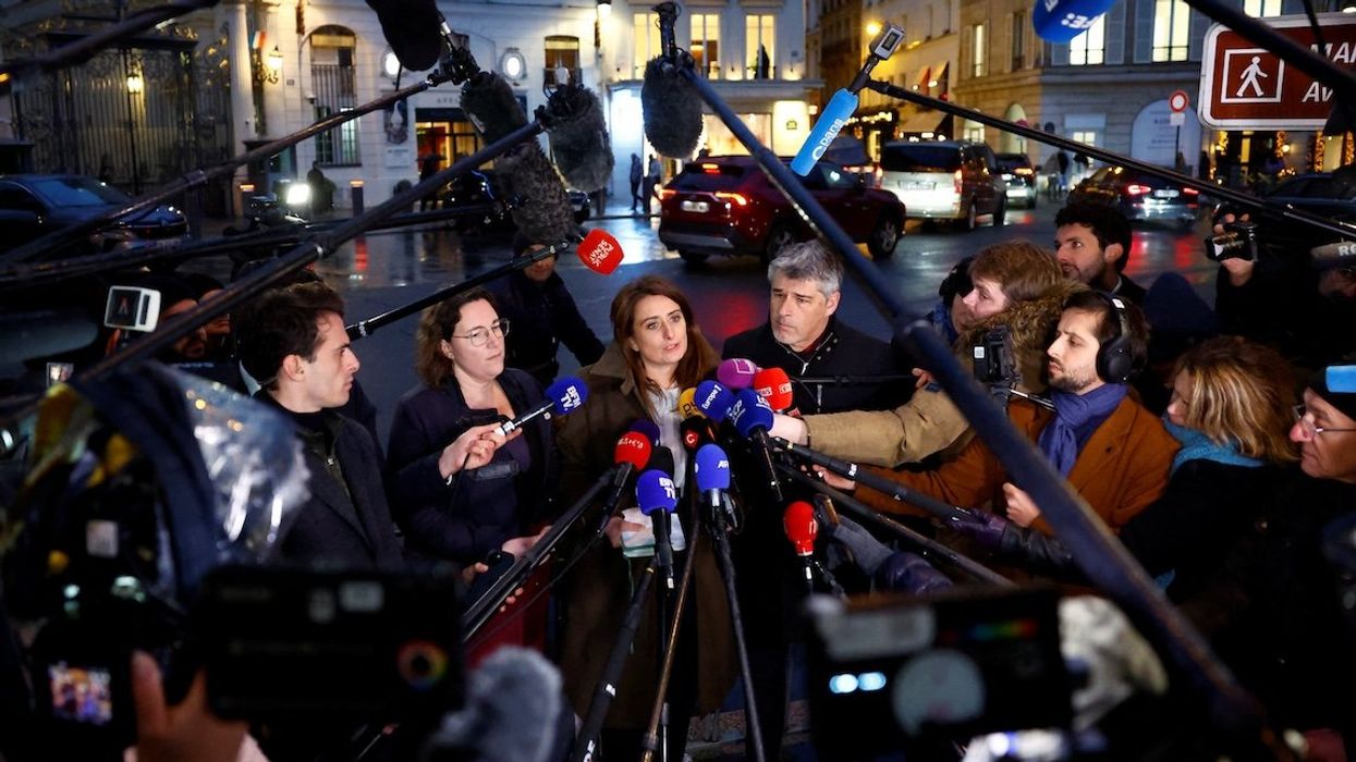 Marine Tondelier, of Les Ecologistes party, talks to journalists next to colleagues as they leave a meeting at the Elysee Palace in Paris on Dec. 10. They had met with the French president as part of consultations aimed at appointing a new prime minister.