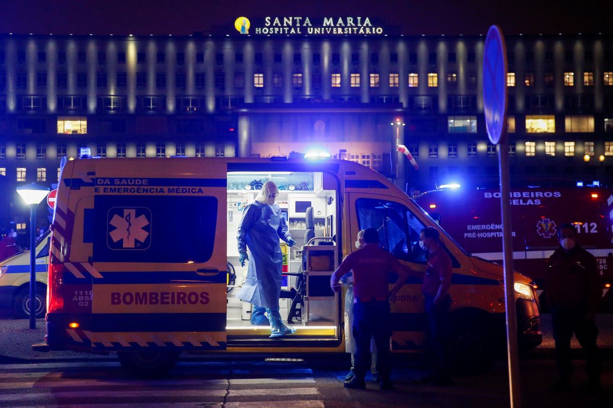 Medical personnel stand next to ambulances with COVID-19 patients as they wait in the queue at Santa Maria hospital, amid the coronavirus disease (COVID-19) pandemic in Lisbon, Portugal, January 27, 2021