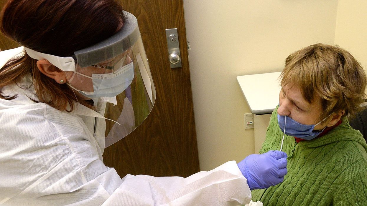 medical professional administers a COVID-19 test