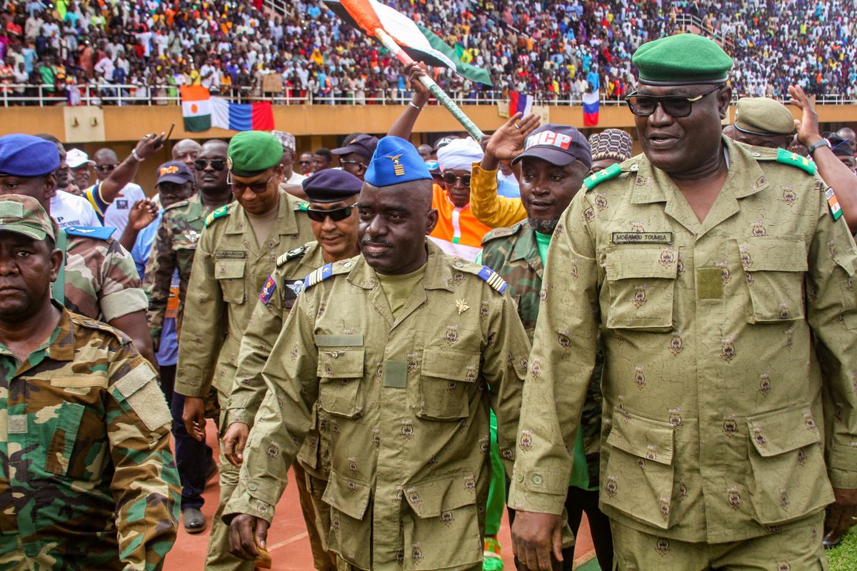 Members of a military council that staged a coup in Niger attend a rally at a stadium in Niamey, Niger.