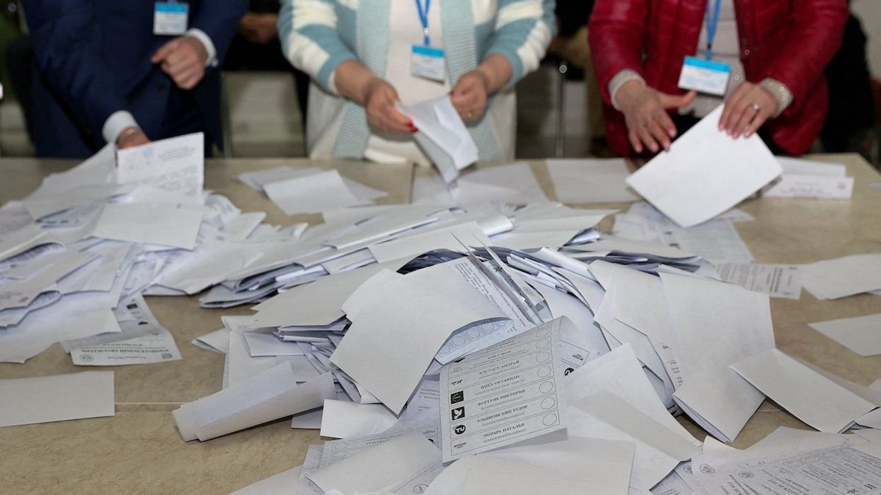 Members of an electoral commission count votes after polling stations closed in the course of Moldova's presidential election and a referendum on joining the European Union, in Chisinau, Moldova October 20, 2024.