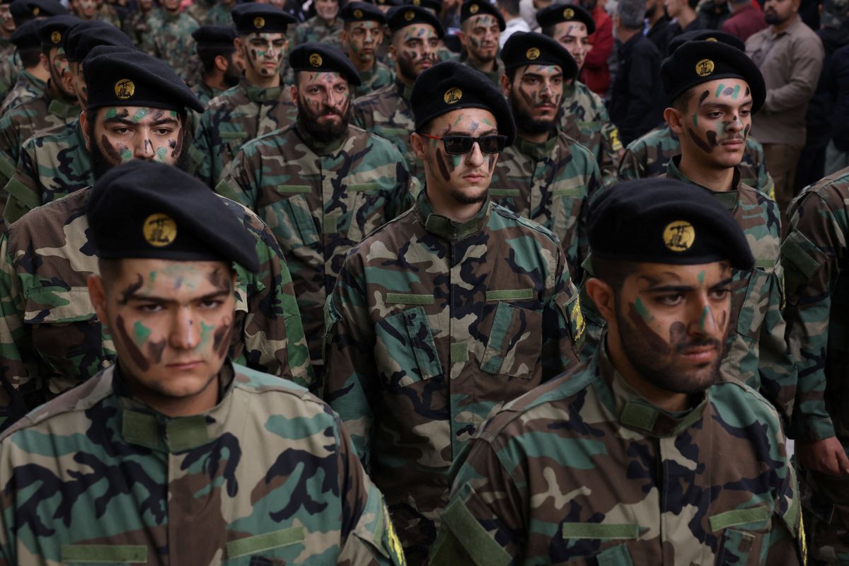 Members of Hezbollah take part in the funeral of Hezbollah member Abbas Shuman