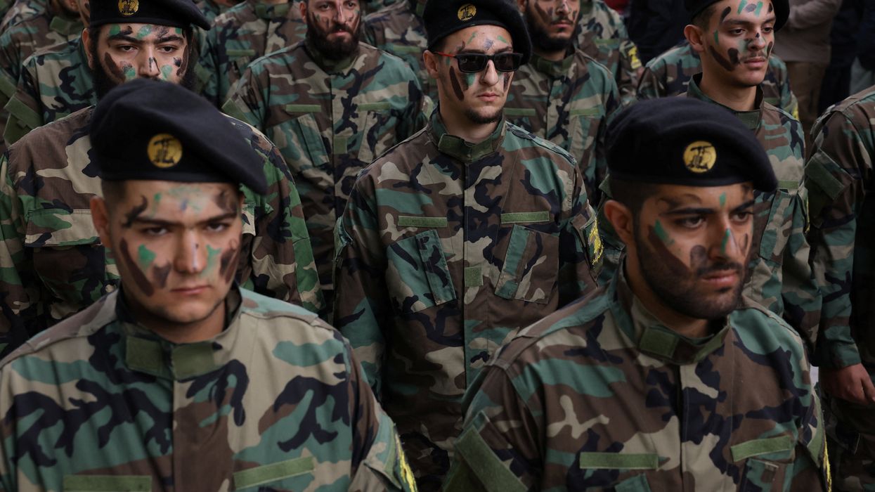 Members of Hezbollah take part in the funeral of Hezbollah member Abbas Shuman