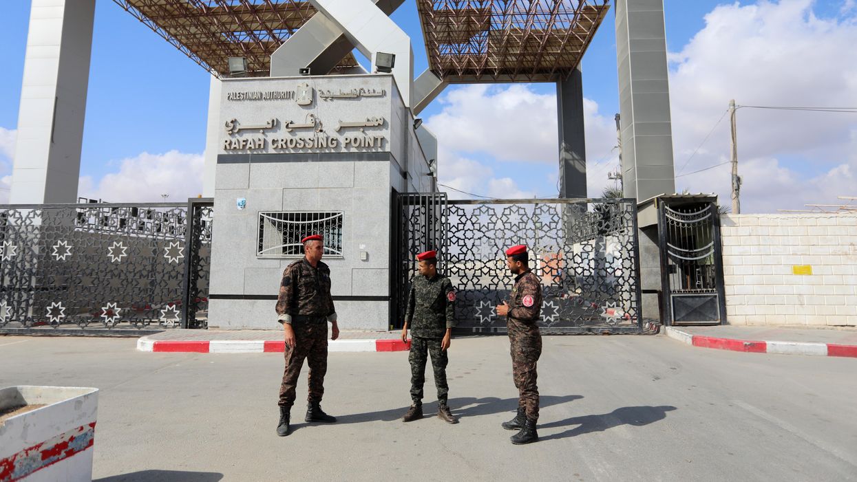 Members of Palestinan security forces stand guard at the closed off Rafah border crossing to Egypt in the southern Gaza Strip, on August 23, 2021
