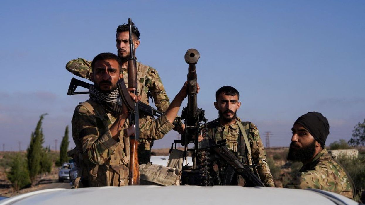 Members of Syrian security forces ride on a back of a truck after Syrian troops entered the predominantly Druze city of Sweida, Syria July 15, 2025.