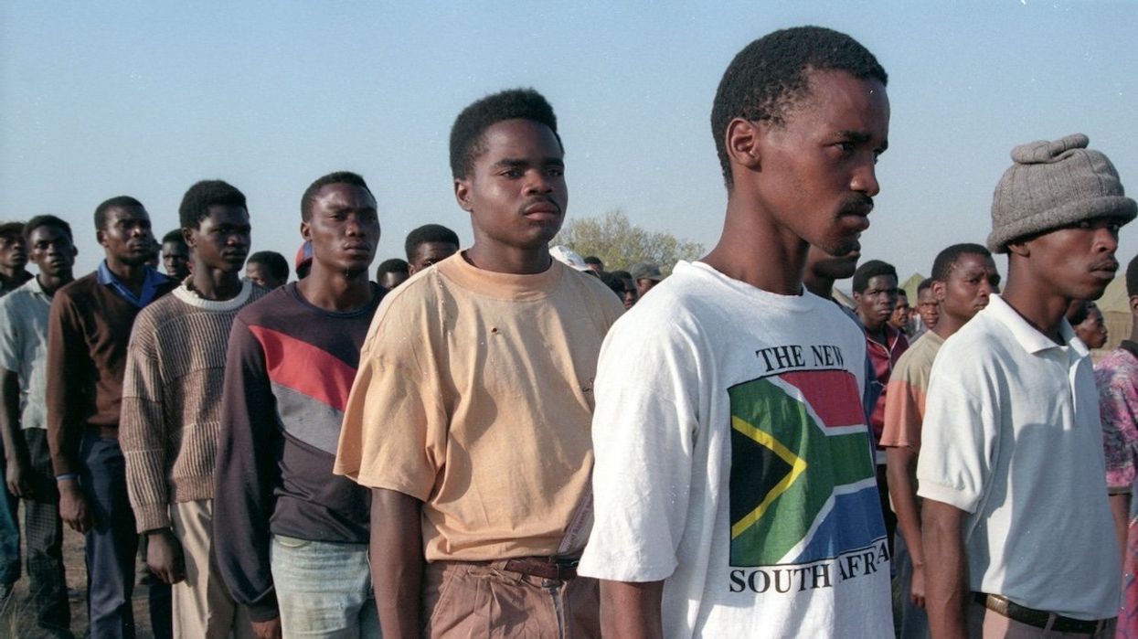 Members of the armed wing of Nelson Mandela's African National Congress line up waiting to vote in a military base north of Pretoria, on April 26, 1994.