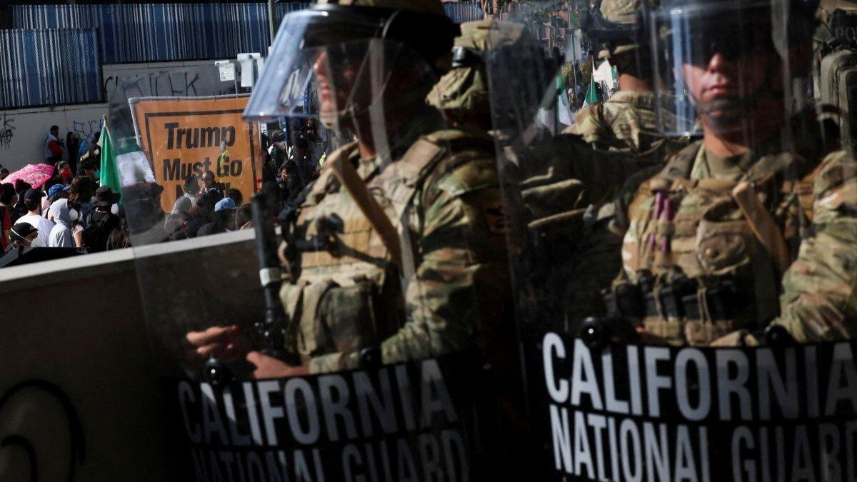 ​Members of the California National Guard stand in a line, blocking an entrance to the Federal Building, as demonstrators gather nearby, during protests against immigration sweeps, in Los Angeles, California, USA, on June 9, 2025.