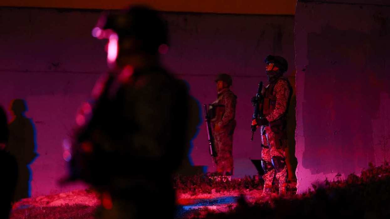 Members of the Mexican army stand guard at a roundabout on a main avenue in Guadalajara, Mexico, on February 23, 2026.