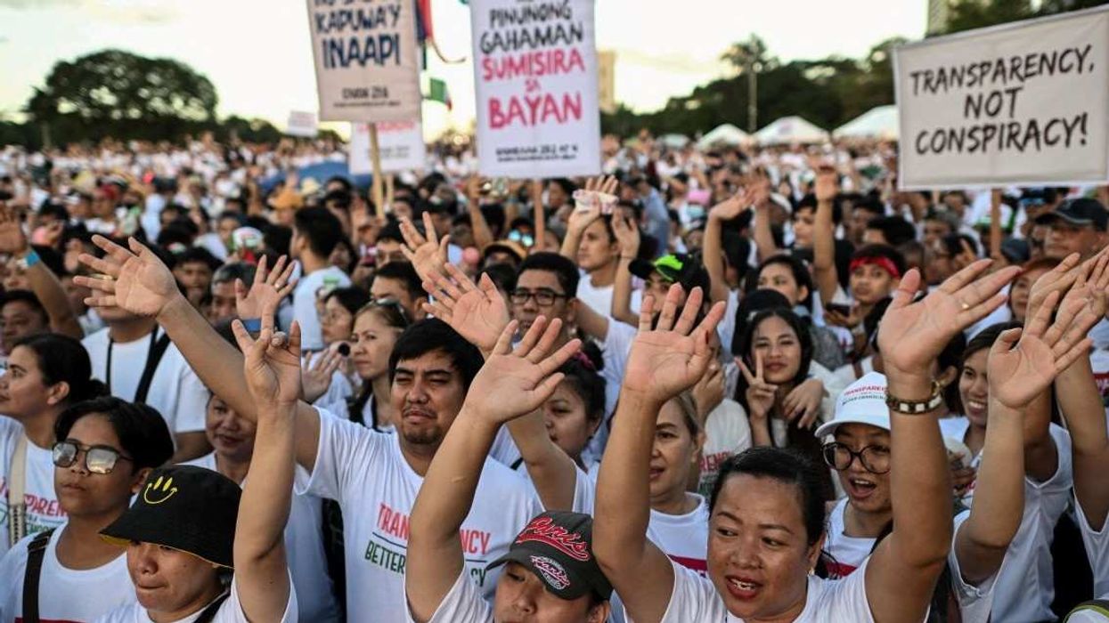 Members of the religious group Iglesia ni Cristo (Church of Christ) wave their hands during the first of a three-day anti-corruption protest at the Quirino Grandstand, Manila, Philippines, November 16, 2025.