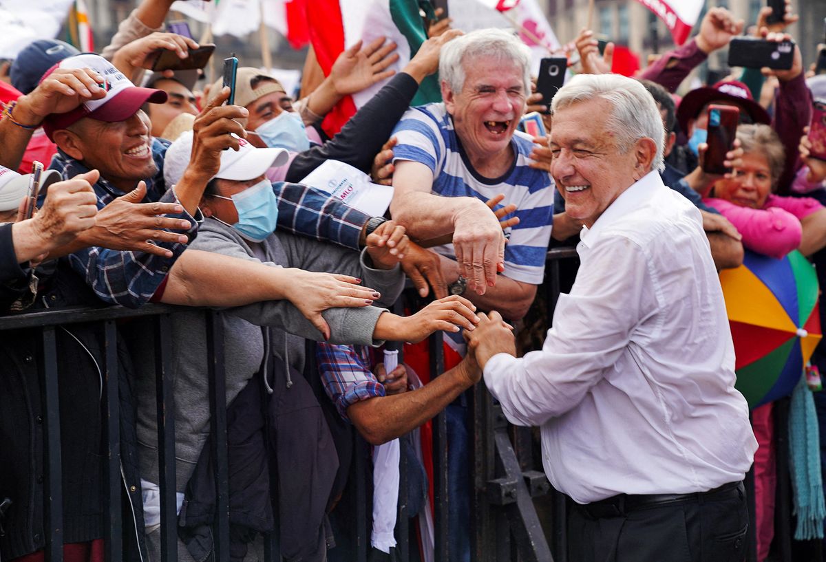 Mexican President Andrés Manuel López Obrador greets supporters after attending a march in support of his government policies in Mexico City.