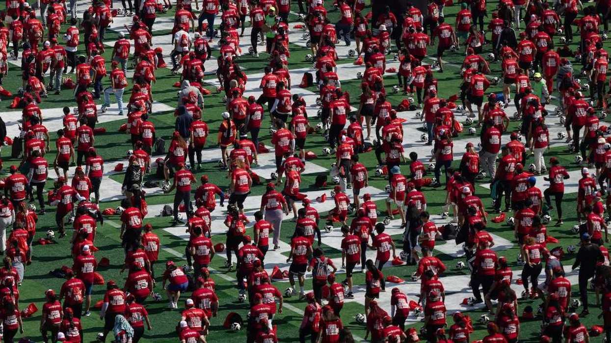 Mexicans participate in an attempt to set a new Guinness World Record, where organisers aim to break the mark for the world's largest football (soccer) lesson as part of efforts to promote the country ahead of the 2026 FIFA World Cup, at Zocalo square in Mexico City, Mexico, March 15, 2026.