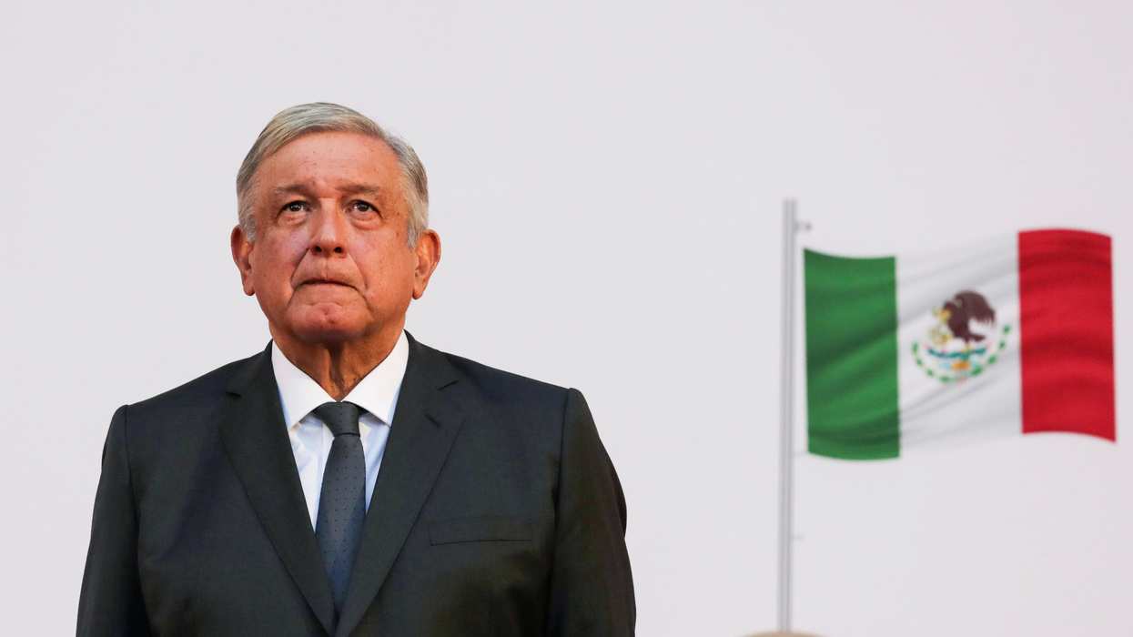 Mexico's president, Andres Manuel Lopez Obrador, listens to the national anthem after addressing the nation on his second anniversary as the President of Mexico, at the National Palace in Mexico City, Mexico, December 1, 2020.