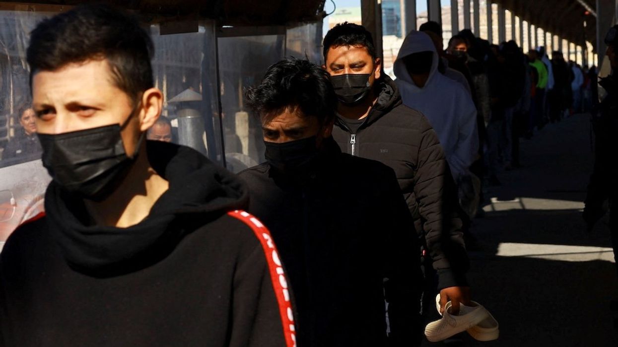 Migrants line up to leave the United States for Mexico after being deported across the Paso del Norte international border bridge after President Donald Trump promised mass deportation operation, as seen from Ciudad Juarez, Mexico, on Jan. 23, 2025.