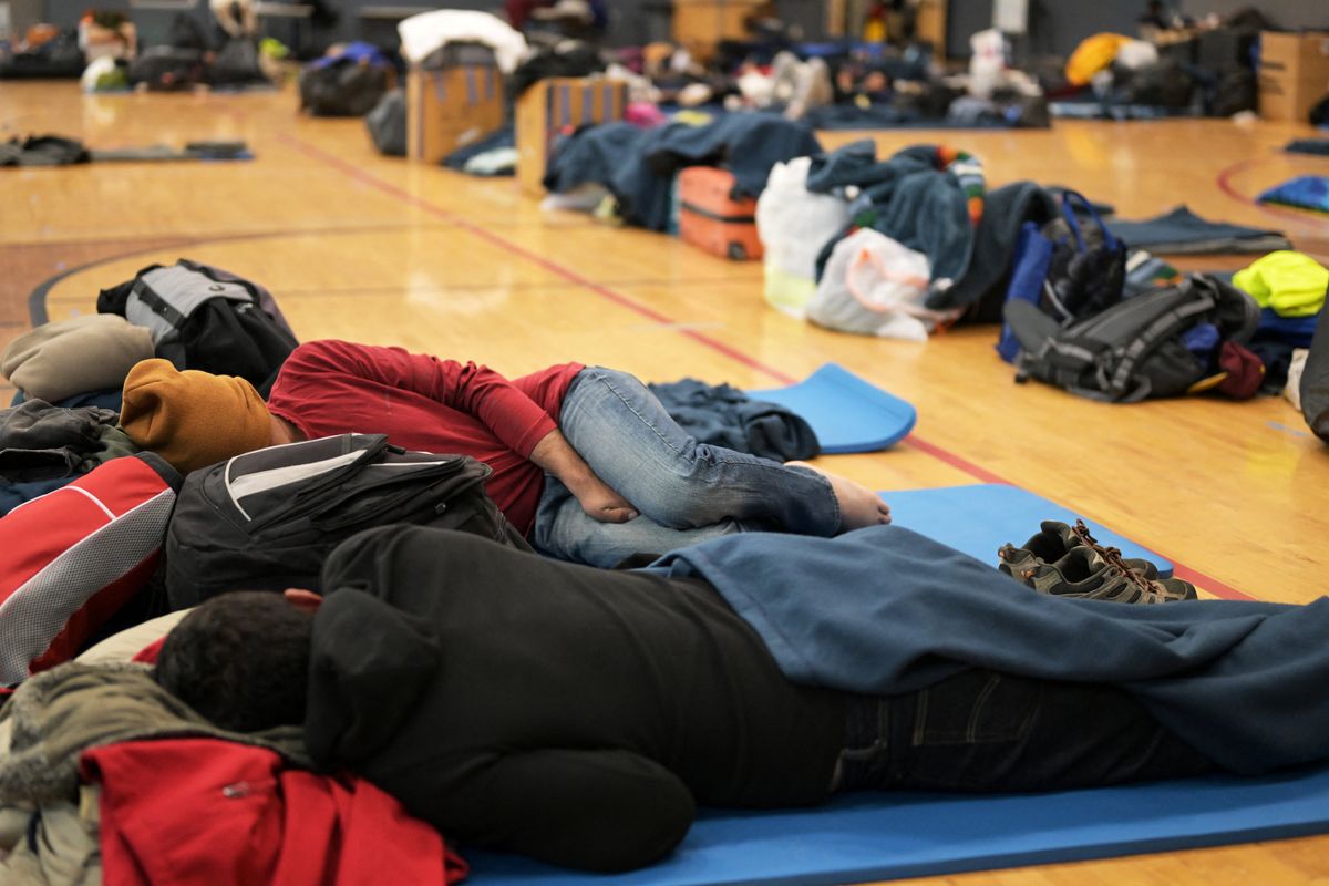 Migrants share space at a makeshift shelter in Denver, Colo., on Friday, Jan. 13, 2023.