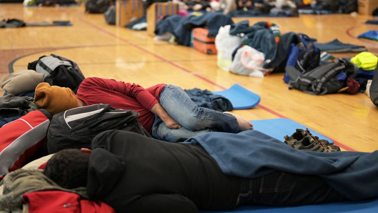 Migrants share space at a makeshift shelter in Denver, Colo., on Friday, Jan. 13, 2023.