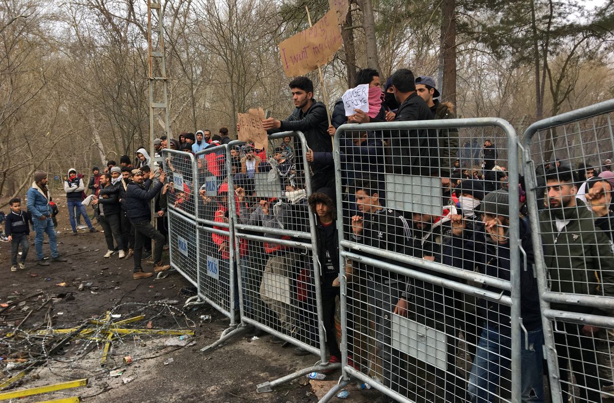 Migrants wait on at Turkey's Pazarkule border crossing with Greece's Kastanies. Reuters