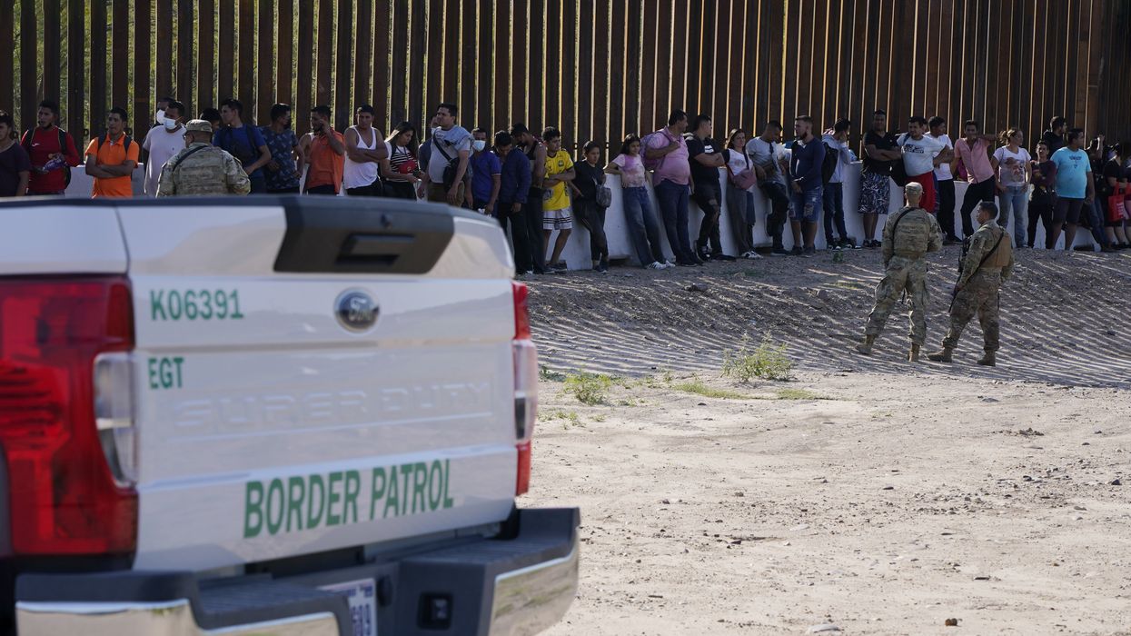 Migrants wait to be transported by border patrol to a detention center in Eagle Pass Texas, USA.