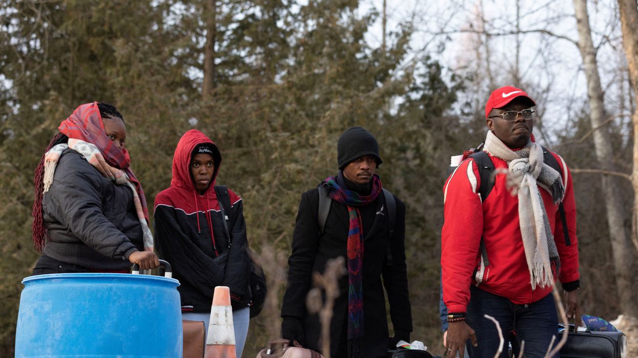 Migrants wait to cross into Canada at Roxham Road, an unofficial crossing point from New York state to Quebec for asylum-seekers.