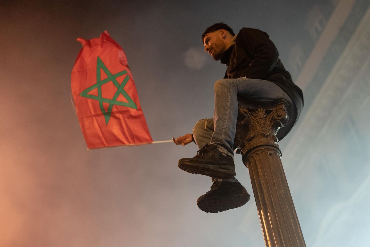 Moroccan fans gather on the Champs Elysees in Paris to celebrate Morocco s qualification for the semifinals of the World Cup.