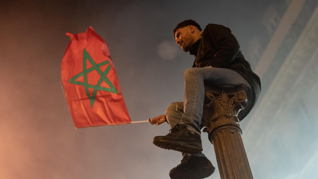 Moroccan fans gather on the Champs Elysees in Paris to celebrate Morocco s qualification for the semifinals of the World Cup.