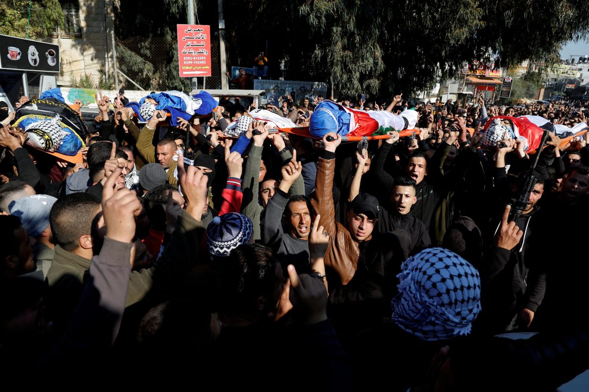 ​Mourners carry the bodies of Palestinians, including militants, killed in an Israeli raid, during their funeral in Jenin