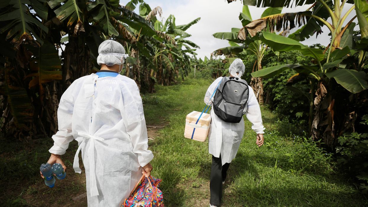 Municipal health workers walk along the Solimoes river banks, where Ribeirinhos (river dwellers) live, before applying the AstraZeneca/Oxford vaccine for the coronavirus disease (COVID-19) to the residents, in Manacapuru, Amazonas state, Brazil, February 1, 2021.