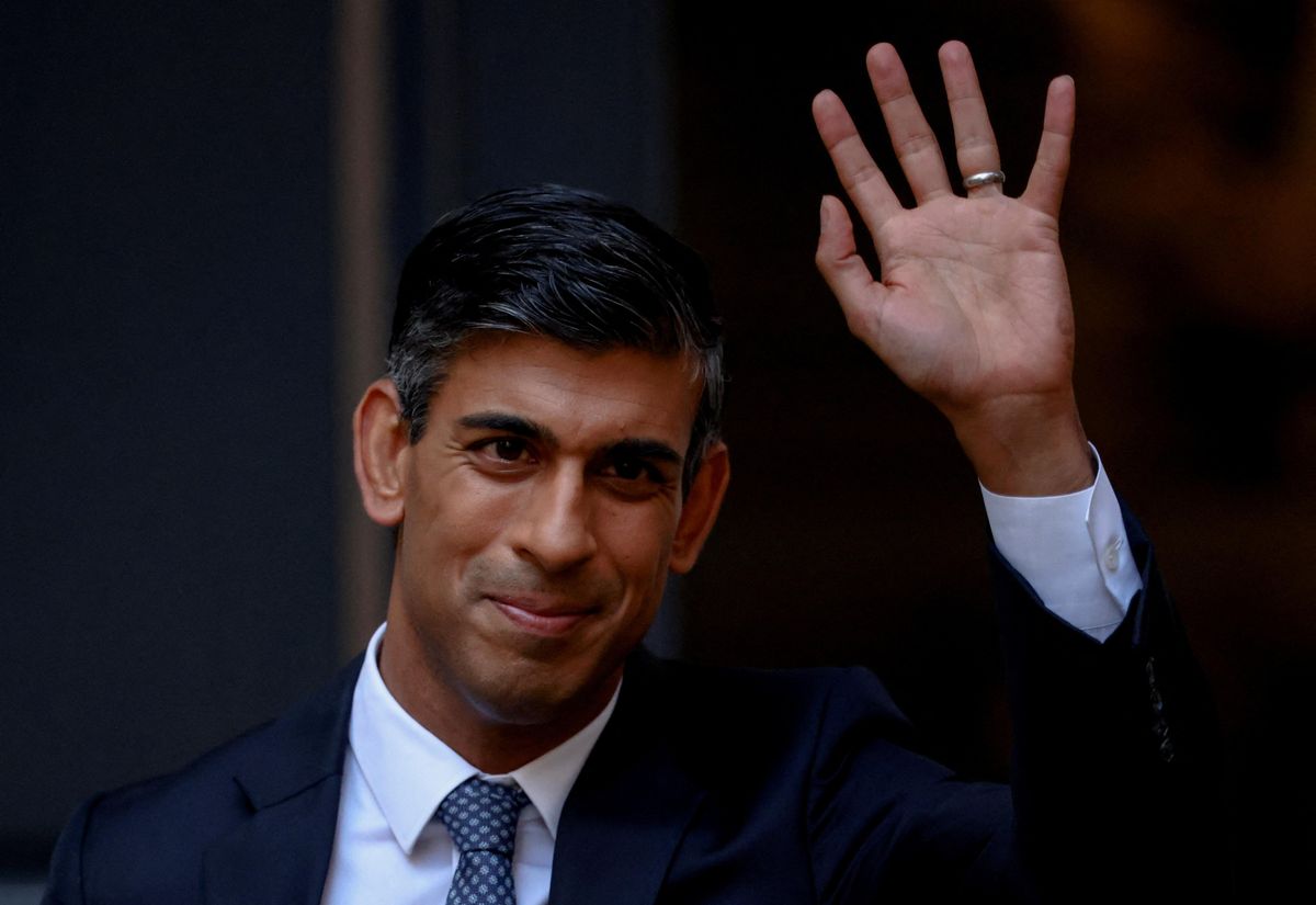 New British Conservative Party leader Rishi Sunak waves outside Tory HQ in London.
