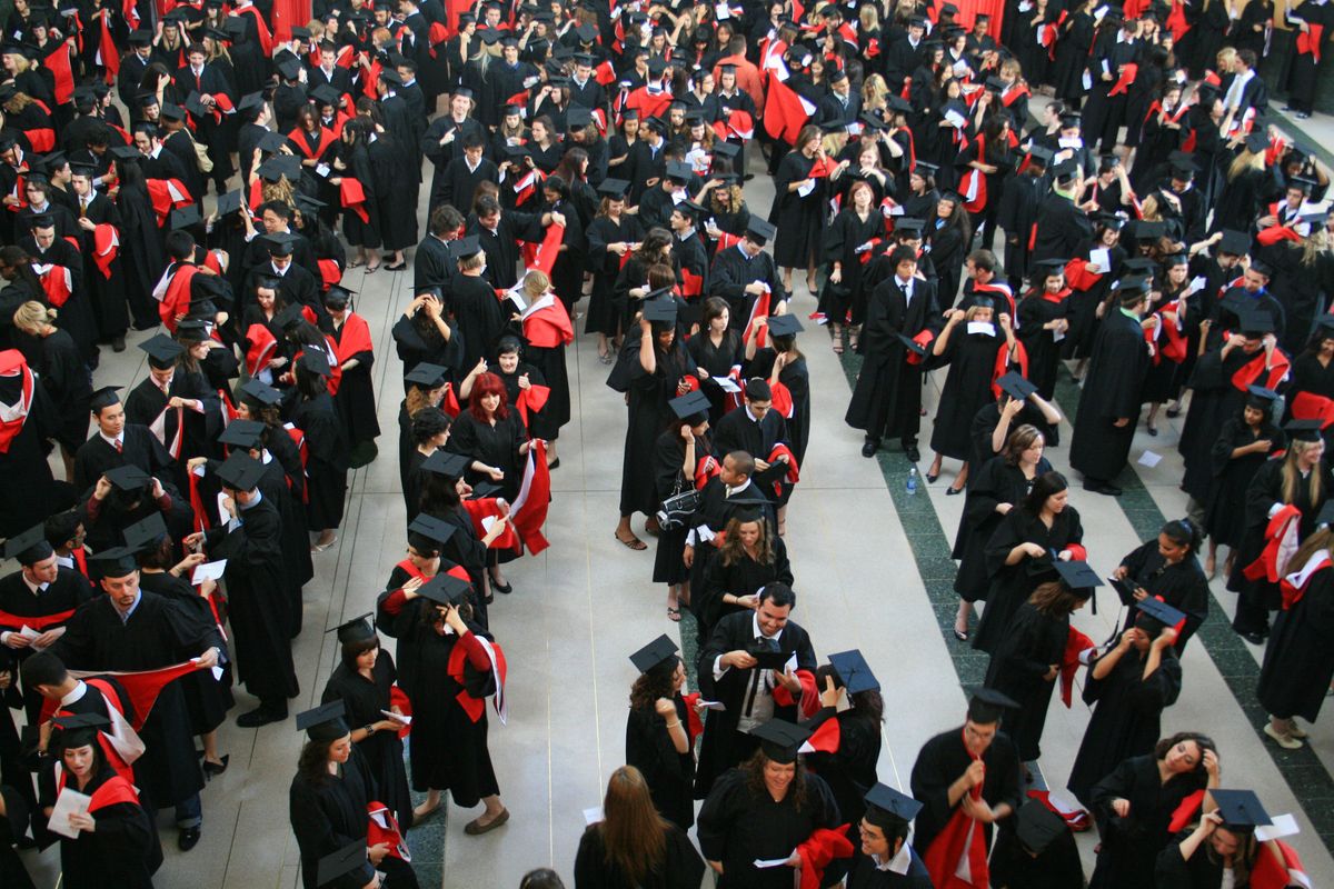 New university graduates line-up in a hall before convocation in Ontario, Canada. 