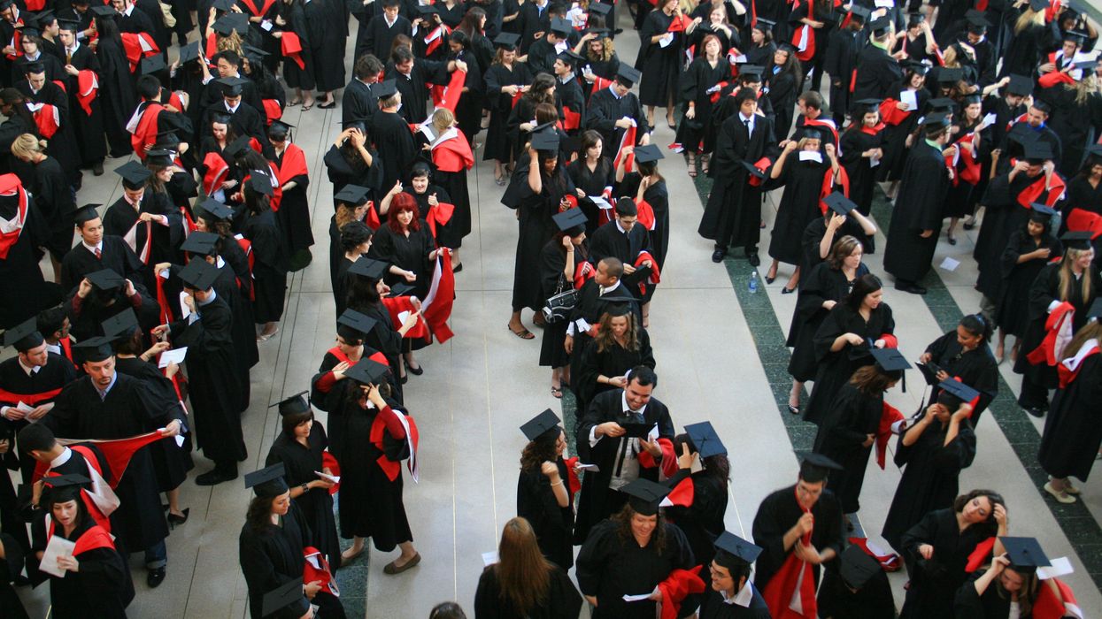 New university graduates line-up in a hall before convocation in Ontario, Canada.