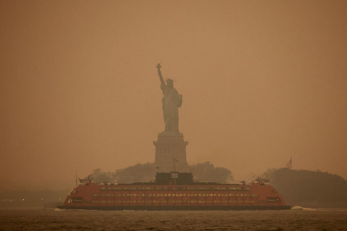 New York City's Statue of Liberty is covered in haze and smoke caused by wildfires in Canada.